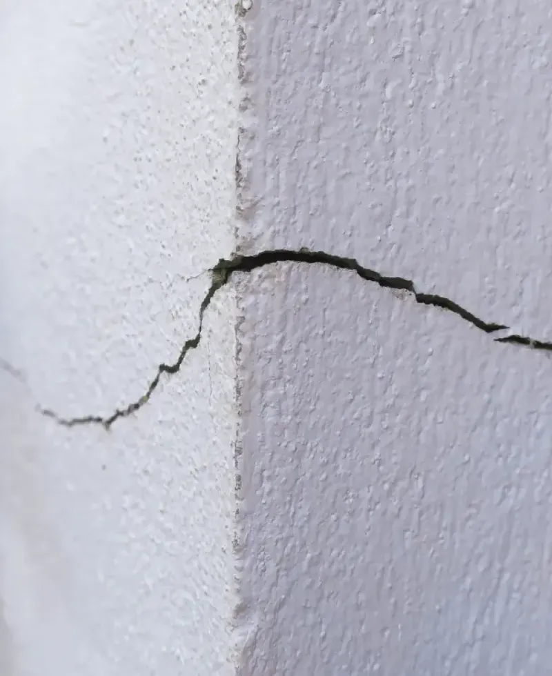 Foundation stress cracks caused by soil erosion.